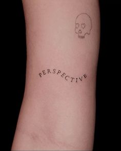 a skull with the word perspective on it's left side arm