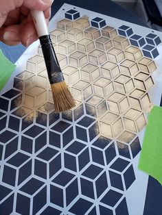 a person is using a brush to paint the pattern