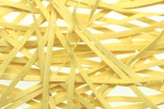 close up view of yellow rubber banding on white background