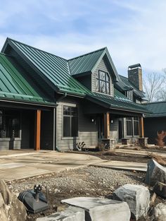 a large house with a green metal roof