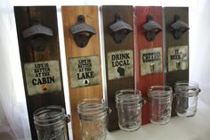 four mason jars lined up next to each other in front of wooden plaques with sayings on them