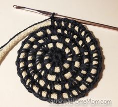 a crochet doily with a pair of scissors next to it