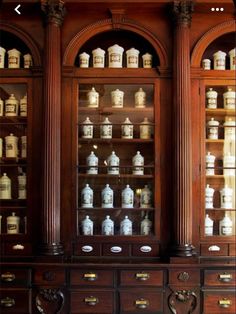 an old wooden cabinet with many jars on it