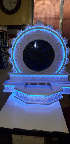 an illuminated clock sitting on top of a table