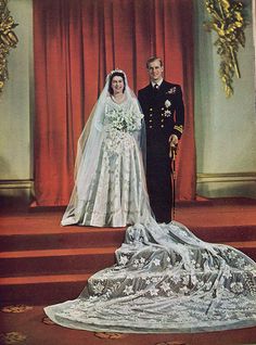 an old photo of a bride and groom on their wedding day in front of a red curtain