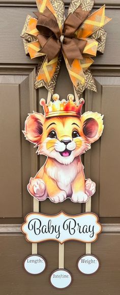 a door hanger with a lion wearing a crown on it's head and name