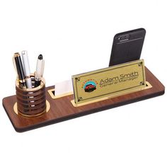 a wooden desk organizer with pens, pencils and phone on it's stand