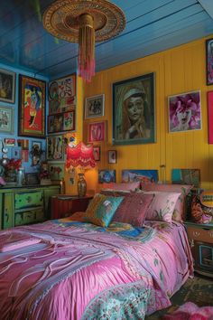 a bedroom decorated in bright colors with pictures on the wall and ceiling above the bed