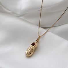 "Solid 14k Yellow Gold Puffy Soccer Shoe Necklace, Soccer Shoe Pendant with Box Chain, Soccer Shoe Necklace Charm, 14K Gold Soccer Shoe Charm, Can be worn with other necklaces, great for layers. A Perfect 14K Gold gift. . . . * Pendants Measurements With Bail: (28 x 9 mm) * Chain is included ( 1MM Box Chain) * Stamp: Real 14k Gold * Never gold filled or plated * Packaged With Free Gift Box . . . . If you have any questions, just hit the \"Message the Seller\" button ( bottom right of the page) a Yellow Gold Plated Charm Necklace With Box Chain, Yellow Gold-plated Charm Necklace With Box Chain, 14k Gold Charm Necklace With Box Chain, 14k Gold Charms Necklace For Keepsake, Yellow Gold Charms Necklace Keepsake, Yellow Gold Box Chain Necklace As Gift, 14k Yellow Gold Charm Necklace With Box Chain, 14k Gold Pendant Necklace For Keepsake, Gold Tarnish-resistant Necklace For Keepsake