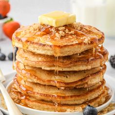 a stack of pancakes topped with butter and syrup