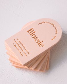 a stack of business cards with the word bossie printed on one side and gold lettering on the other