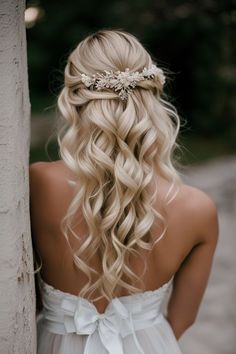 the back of a woman's head with long blonde hair and a flower in her hair