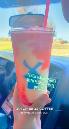 a person holding up a drink in their hand with the caption peach mango frosted with pomegranate drizzle