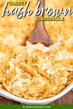 cheesy hashbrown casserole in a white dish with a wooden spoon