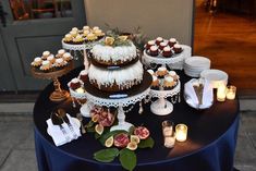 a table topped with lots of cakes and desserts