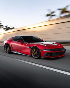 a red sports car driving down the road