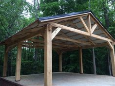 a large wooden structure sitting in the middle of a forest