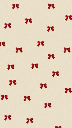 red bows are flying in the air on a white background with light brown and cream colors