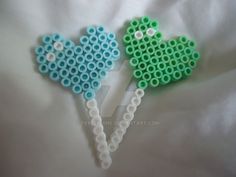 two green and blue heart shaped lollipop sticks