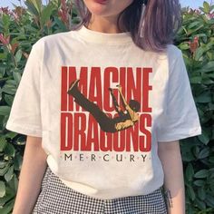 a woman wearing a t - shirt that says imagine the dragon's mercury