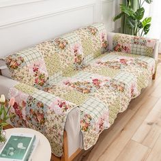 a living room with a couch covered in floral fabric