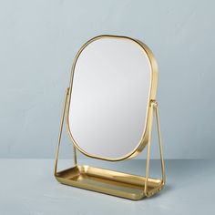 a mirror sitting on top of a metal stand