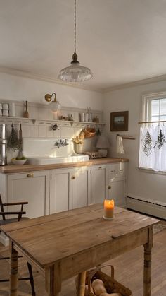 a wooden table sitting in the middle of a kitchen