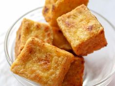 small pieces of bread sitting in a glass bowl