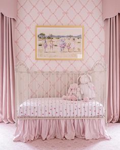 a baby's room with pink curtains and a white crib in the corner