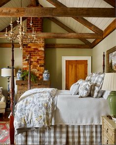 a bed sitting in a bedroom next to a brick wall