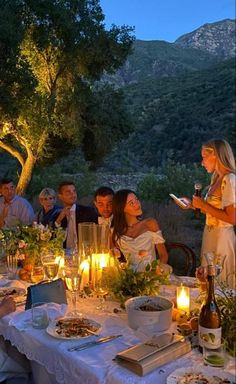 a group of people sitting around a dinner table