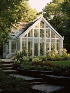 a white house surrounded by trees and flowers