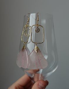 Discover elegance in these artisanal resin earrings made with real flower petals. Each piece captures nature's beauty and craftsmanship, featuring duo of pink petals, enchanted with unique moon charm and stylish geometric connectors. Key Features: - Real pressed flower petals (please, let me know if you know the name!) - Moon charm with sparkly crystals - Geometric connectors - Versatile for any occasion - Lightweight and comfortable Packaging: These earrings arrive nestled in a white organza po Flower Statement Earrings, Sparkly Crystals, Pink Petals, Moon Charm, Resin Earrings, Pressed Flower, Real Flowers, Flower Petals, Pressed Flowers