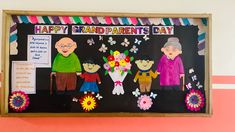 an old man and woman are standing in front of a sign that says happy grandparents day