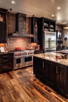 a kitchen with an oven, stove and refrigerator in it's center island area