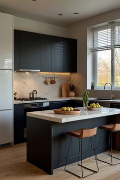 a kitchen with an island and two stools in front of the counter top that has fruit on it