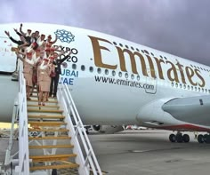 a group of people standing on the stairs to an airplane