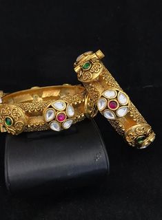 Simply a mark of royalty and elegance!! Handcrafted in brass with gold plating and fine quality Kundan stones. Set of 2 For wrist Size 2.4 Inner Diameter: 2.25 inches Easily Openable with a screw The bangles are the same as shown in the pictures. We have only one piece in this color and design, hence you get what you see in the pictures. Elegant Gold Jeweled Bangle, Elegant Jeweled Gold Bangle, Gold Brass Bangle With Intricate Design, Heavy Antique Gold Bracelets, Gold Bracelets With Intricate Design For Marriage, Gold Bracelets With Detailed Design For Marriage, Gold-plated Jeweled Gold Bracelets, Ornate Gold Bangle With Intricate Design, Formal Gold Jeweled Bangle