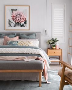 an instagram photo of a bed with pillows and blankets on it, in the middle of a room