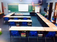 an empty classroom with desks and chairs