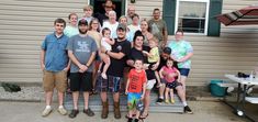 a group of people standing in front of a house