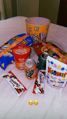 various snacks and candy sitting on a table