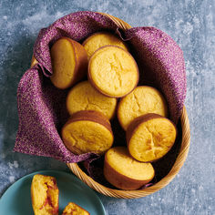 a basket full of cookies next to a plate with one cut in half