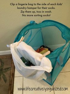 a laundry hamper is sitting on the floor in front of a wall with a quote