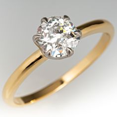 a yellow gold engagement ring with an oval cut diamond in the center, on a white background