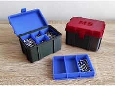 three plastic storage boxes with screws in them on top of a wooden table next to each other