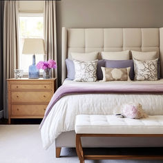 a white bed sitting next to a window in a bedroom