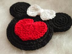 a crocheted mickey mouse head with a heart on it