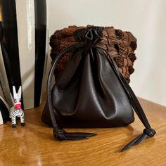 This luscious leather drawstring pouch bag is soft and supple. Made with Dark brown Italian Leather. Drawstring loops slip over your wrist softly. This large sized pouch bag has so many uses. Color - Dark Brown Pouch size Over all is approx -6 1/4" H X 5 1/2" W Pull drawstrings to close at top. Back to shop - http://www.etsy.com/shop/shirlbcreationstoo Luxury Gift Tote Pouch, Luxury Leather Pouch As Gift, Luxury Leather Gift Pouch, Leather Bucket Bag Pouch For Gifts, Leather Pouch Bucket Bag As Gift, Bucket Bag With Removable Pouch As Gift, Elegant Leather Pouch For Personal Use, Leather Bucket Bag With Dust Bag As Gift, Soft Leather Bucket Shoulder Bag As Gift