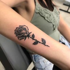 a woman with a rose tattoo on her arm